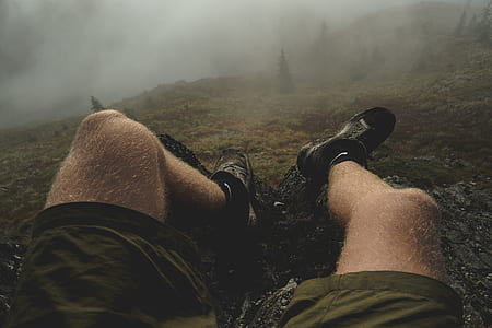 person sitting near gray stone during daytime thumbnail