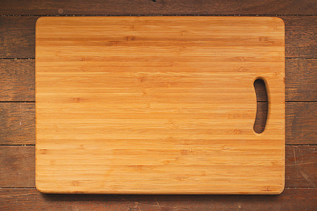 rectangular brown wooden chopping board on hardwood thumbnail