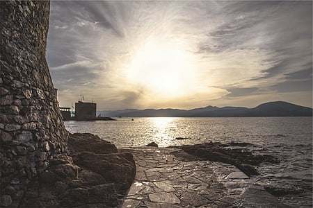 bricks wall beside body of water thumbnail