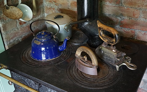 blue kettle near sadiron on vintage cooking set thumbnail