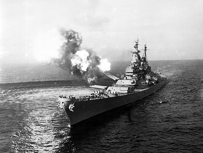 USS Missouri fires a salvo from its 16-inch guns at shore targets during Korean War thumbnail