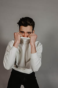 man in white sweater hiding his mouth thumbnail