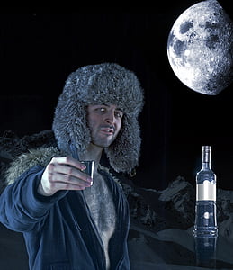 man holding gray shot glass during full moon thumbnail