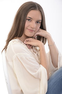 woman wears white trumpet-sleeved shirt and blue denim bottoms thumbnail