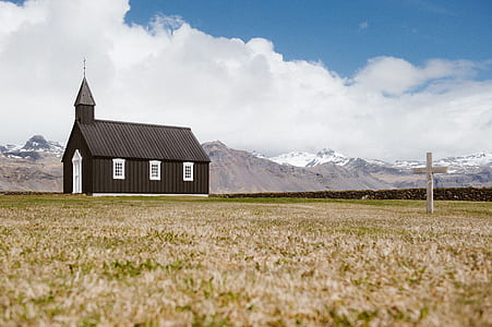 wooden cross struck near on church under cloudy sky thumbnail