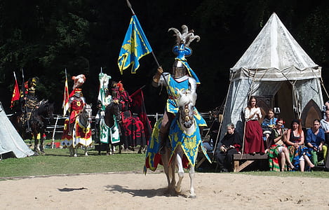 man in battle suit riding on horse during daytime thumbnail