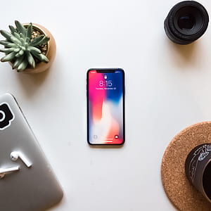 space gray iPhone X near succulent plant and laptop thumbnail