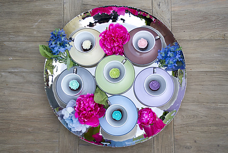 round grey metal tray and six assorted-color teacups with saucers and flowers on brown surface thumbnail