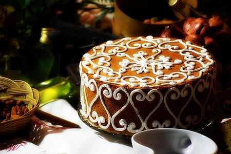 white and brown cake near white ceramic container on white table thumbnail