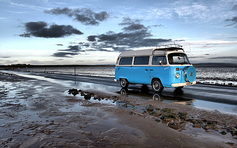 blue and white van on road near ocean during daytime thumbnail