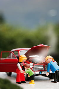 selective focus photography of three minifigs beside red vehicle thumbnail