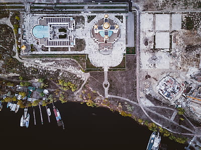 aerial view of city buildings near body of water thumbnail