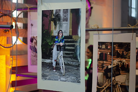 Hanging Photograph of a woman on a Bicycle thumbnail