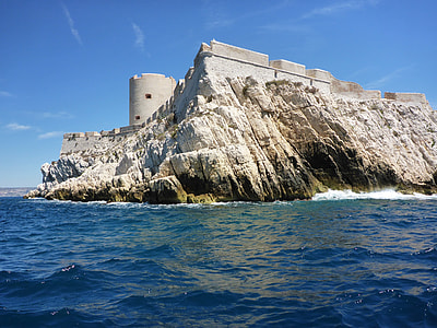 photo of gray concrete castle surrounded by bodies of water thumbnail
