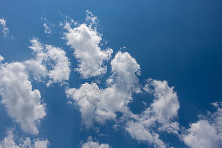 white clouds under blue skies thumbnail