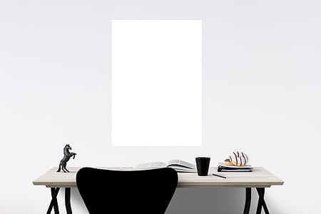 canvas on wall in front of desk with cup, horse figurine, and open book thumbnail