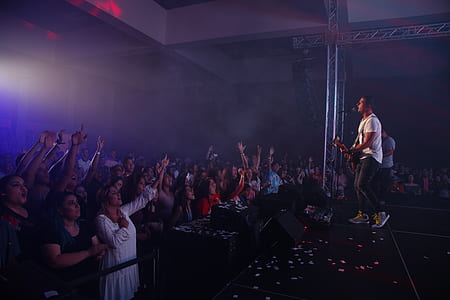 man playing guitar inside black room thumbnail