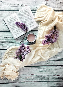 flat lay photography of coffee beside books and scarf thumbnail