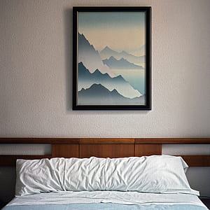 mountains painting near white bed pillow thumbnail