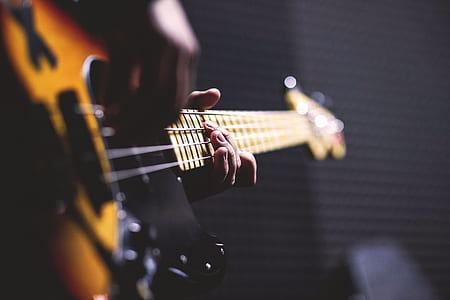 closeup photo of person's hand playing guitar thumbnail