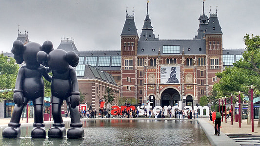 two Kaws statue near building thumbnail
