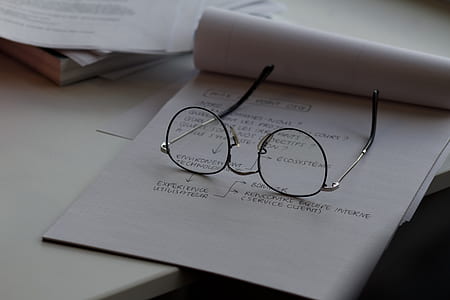 eyeglasses with silver frames on white printer paper thumbnail