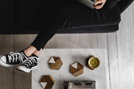 Young woman sitting on the sofa and working on her laptop thumbnail