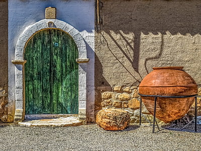 brown clay jar beside concrete wall thumbnail