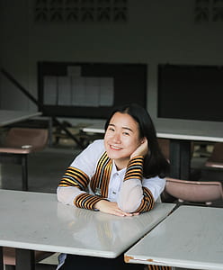 woman smiling while sitting on chair thumbnail