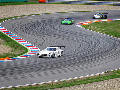three race cars on race track thumbnail