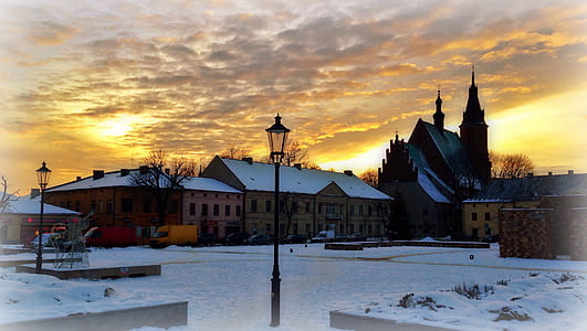 brown houses under orange sky landscape photography thumbnail