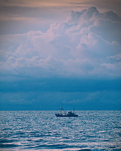 boat at sea during cloudy sky thumbnail