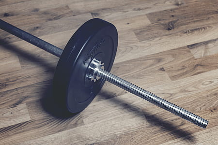 gray dumbbell on parquet floor thumbnail