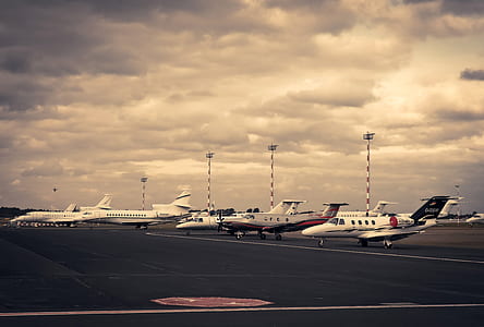 white airplanes on black road during daytime thumbnail