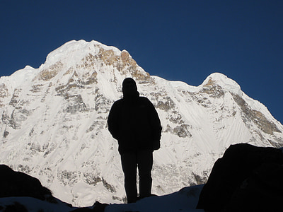 silhouette photography of person standing on mountain thumbnail