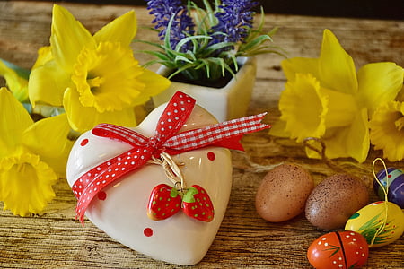 white and red ceramic heart lid near two yellow flowers on brown wooden surface thumbnail