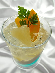 glass of pineapple juice with mint leaf on white textile thumbnail