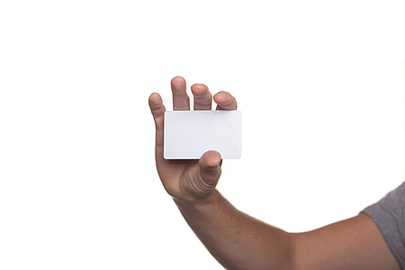 person showing white plastic card thumbnail