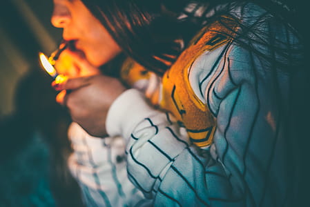 woman lighting up marijuana blunt thumbnail