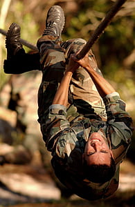 man wearing military uniform doing rope training selective focal photo thumbnail