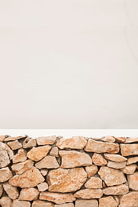 red concrete and stone wall with white background closeup photo thumbnail