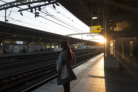 woman standing beside railway thumbnail