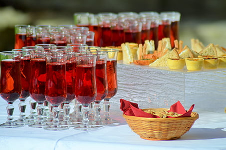 long-stemmed glasses filled with red liquid and clubhouse sandwiches thumbnail