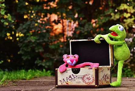 Kermit the frog plush toy holding box beside Pink Panther plush toy thumbnail