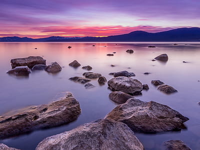 landscape photography of rocks on body of water thumbnail