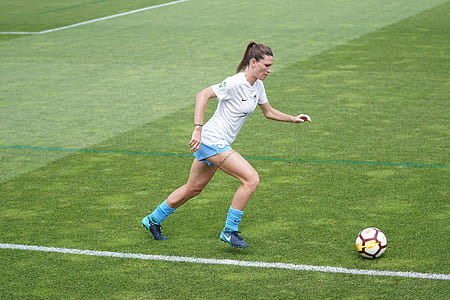 female football player kicking ball thumbnail