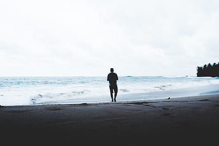 man standing beside ocean thumbnail