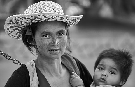 grayscale photo of woman carrying baby thumbnail