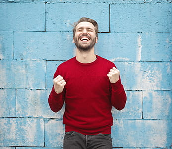 Man in Red Crew-neck Sweatshirt Photography thumbnail