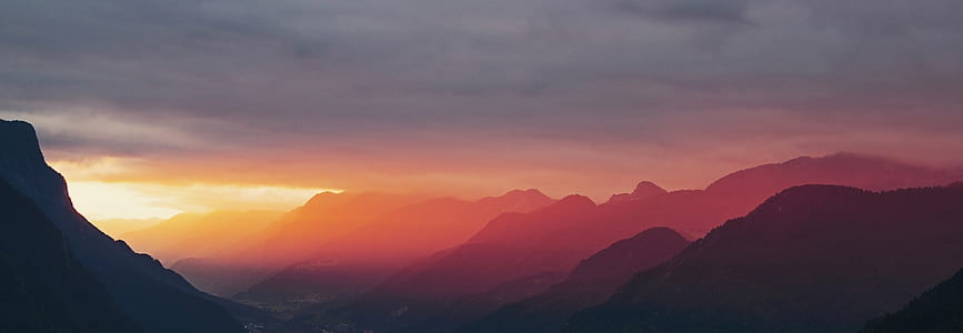 silhouette of mountain during golden jhours thumbnail